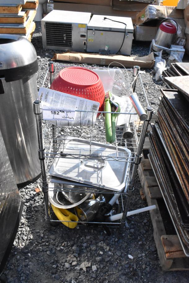 Chrome wire shelving unit with stainless steel lids, colander, and tools. Visible tag indicates buyer must dismantle.