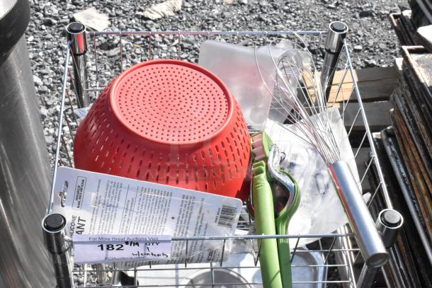 Chrome wire shelving unit with stainless steel lids, red colander, and kitchen tools. Tags indicate dismantling required.