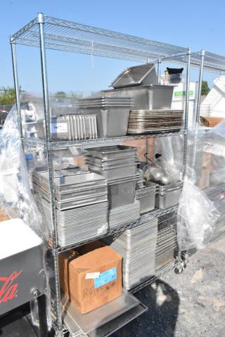 Chrome finish 4-tier wire shelving unit with stainless steel drop-in bins and baking pans. Buyer must dismantle.
