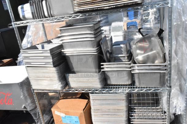 Chrome finish 4-tier wire shelving unit with stainless steel drop-in bins and baking pans. Buyer must dismantle for shipping.