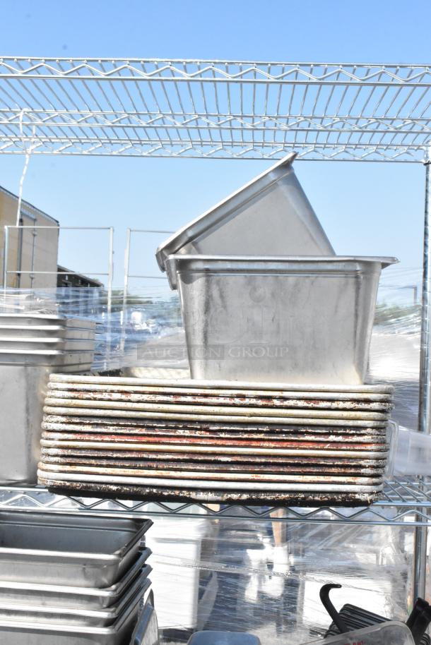 Chrome finish 4-tier wire shelving unit with stainless steel drop-in bins and baking pans. Buyer must dismantle.