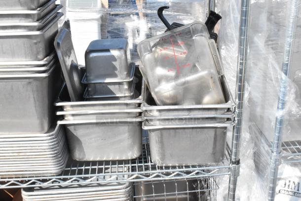 Chrome finish 4-tier wire shelving unit with stainless steel drop-in bins and baking pans. Buyer must dismantle.