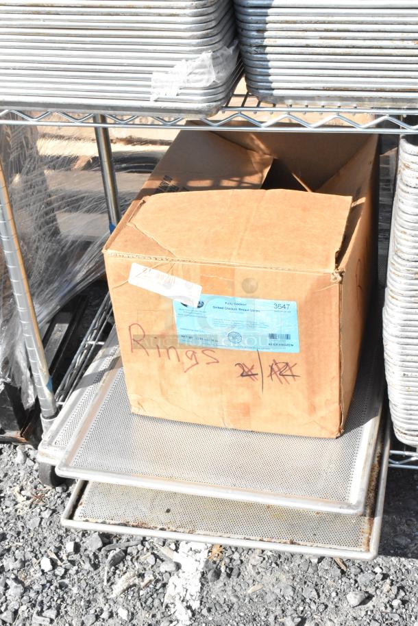 Chrome 4-tier wire shelving unit with stainless steel drop-in bins, baking pans, and a boxed item. Buyer must dismantle.