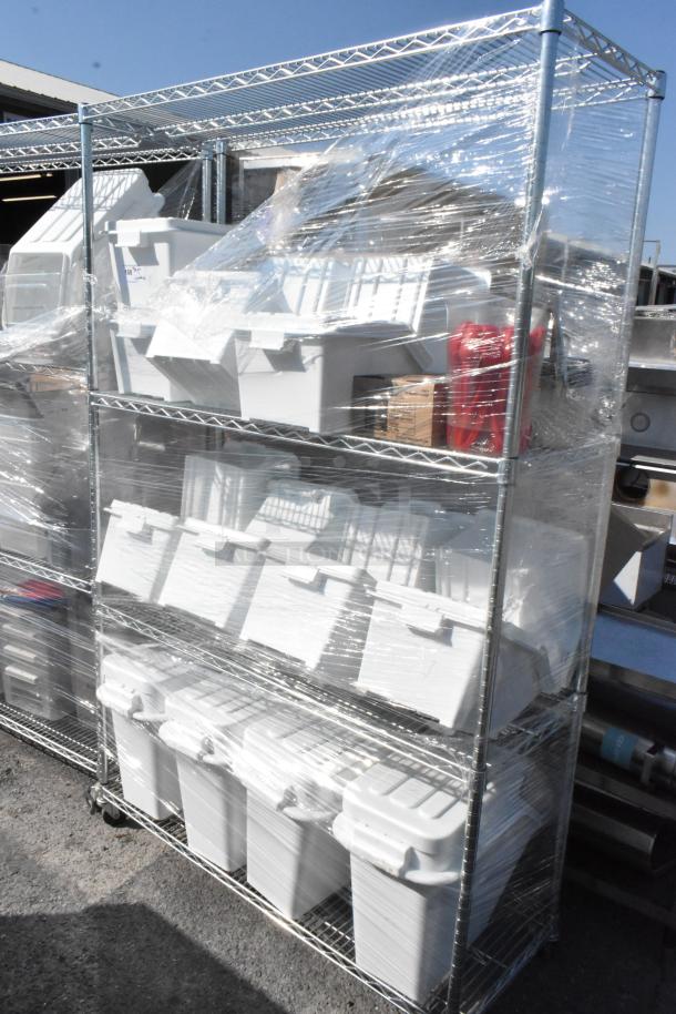 Chrome finish 4-tier wire shelving unit with ingredient bins. Shelving is wrapped in plastic. Buyer must dismantle.