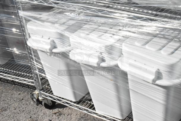 Chrome finish 4-tier wire shelving unit on wheels with ingredient bins, wrapped in plastic. Buyer to dismantle for shipping.