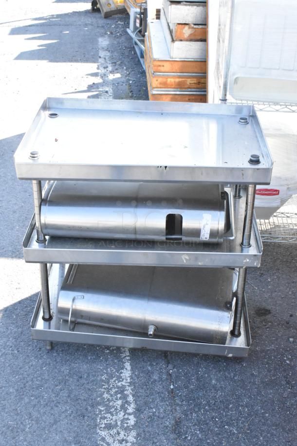 Stainless steel 3-tier stand with two iced tea holder dispensers. Includes visible rubbermaid label. Good condition.