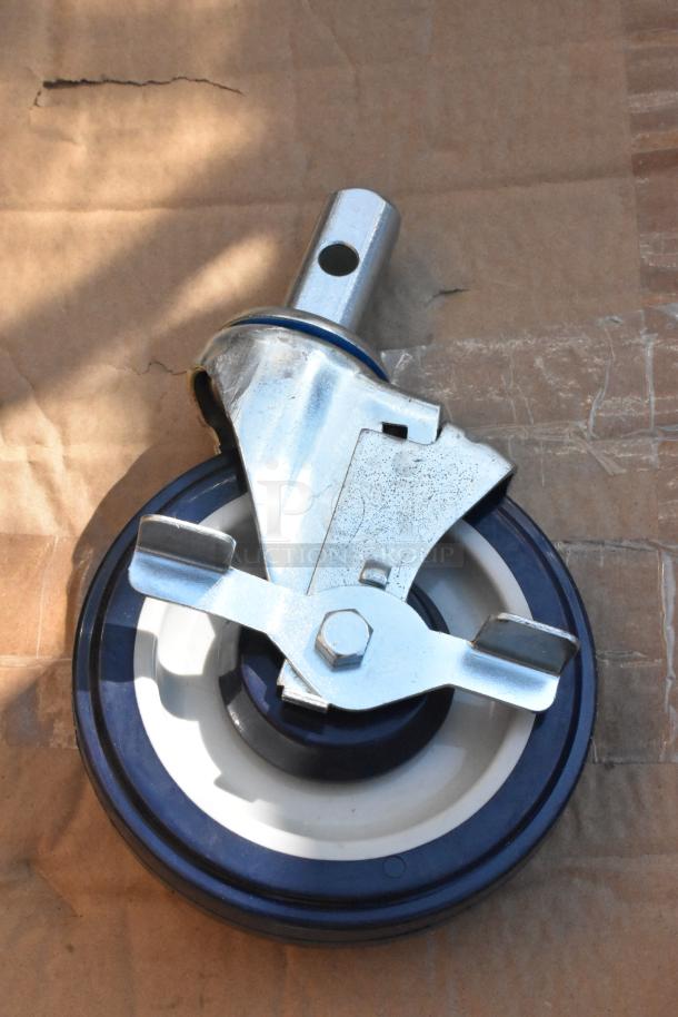 A commercial caster from a lot of 4, new with minor scratches, featuring a steel frame and polyurethane wheel.