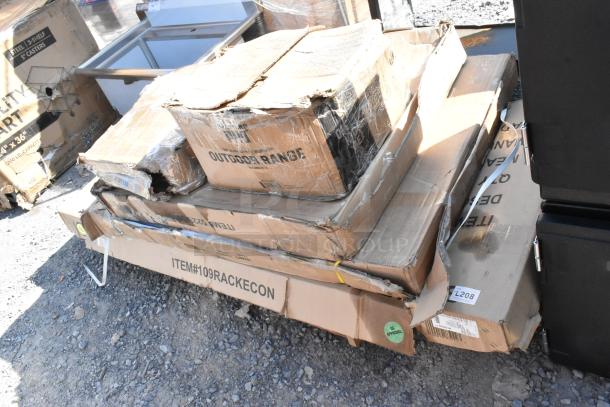 Six brand new items in damaged boxes, including a patio stove and pan rack, visible labels and outdoor range marking.