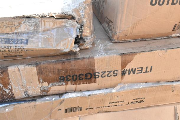 Cardboard boxes labeled with "ITEM #5225G3036," showing signs of scratches and dents, indicating patio stove and pan rack inside.