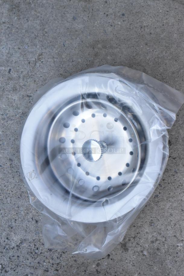 Brand new stainless steel sink strainer wrapped in plastic, part of a commercial 3 bay drop in sink. Scratch and dent condition.