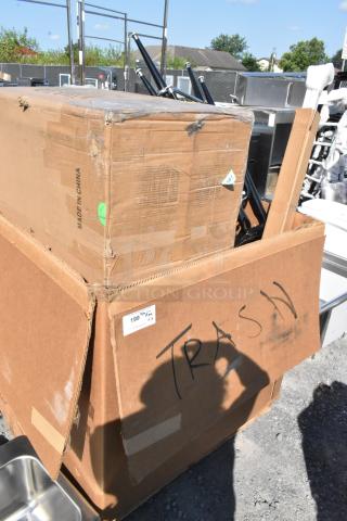 Cardboard box labeled "Trash" containing scratch and dent items, including a dish cabinet and table. Box is marked "Made in China."