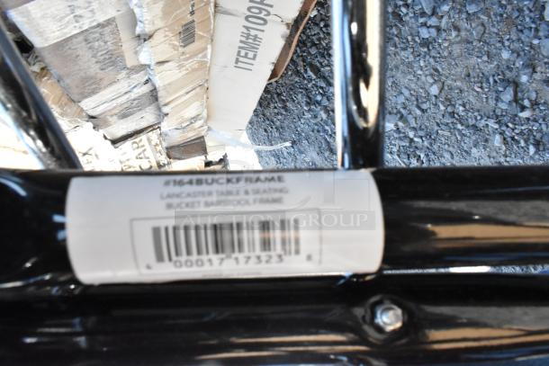 Label on black frame reads “#164BUCKFRAME, Lancaster Table & Seating, Bucket Barstool Frame” with a barcode.