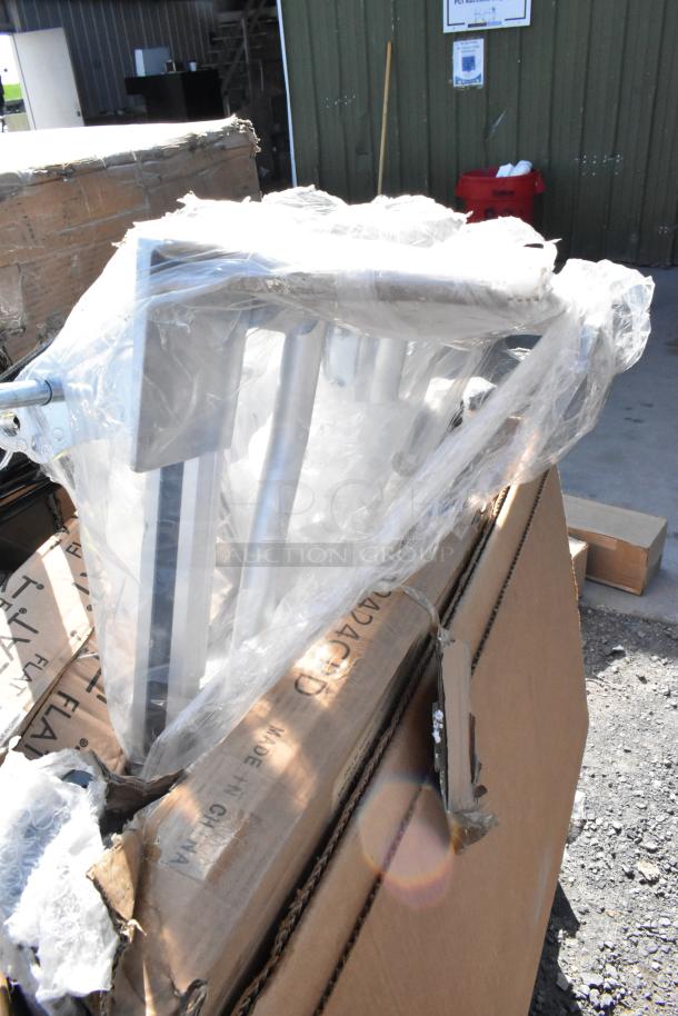 Alt text: New scratch and dent auction items in box, including a metal frame in plastic wrap; "Made in China" visible on box.