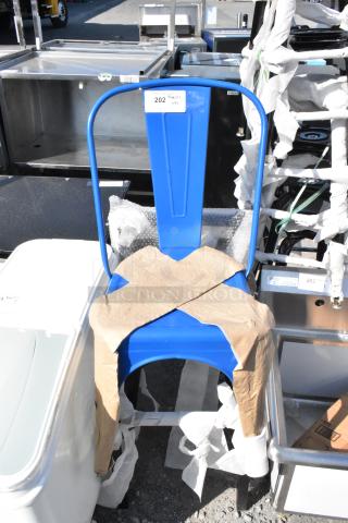 Blue Tolix style bar-height chair, scratch and dent, brand new, protective wrapping. Auction tag indicates item 202.