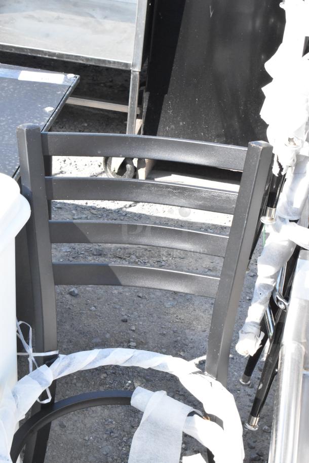 Black metal ladder back dining chair frame, new condition, visible protective wrapping.