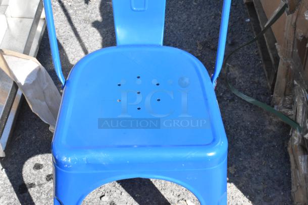 Blue bar height Tolix style chair, new condition, metal construction with perforated seating, slight scratch visible.
