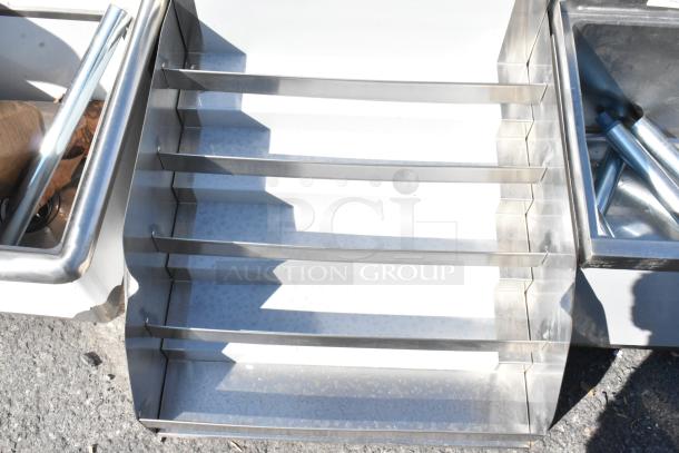 Brand new Regency 600LDR2624, a 24" five-tiered stainless steel liquor display rack, 26" deep, without legs.