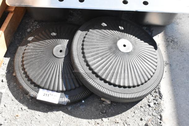 Two brand new black metal table bases with decorative ridges, labeled with a tag reading "211 2x quantity."