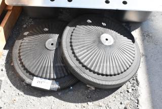 Two brand new black metal table bases with decorative ridges, labeled with a tag reading "211 2x quantity."
