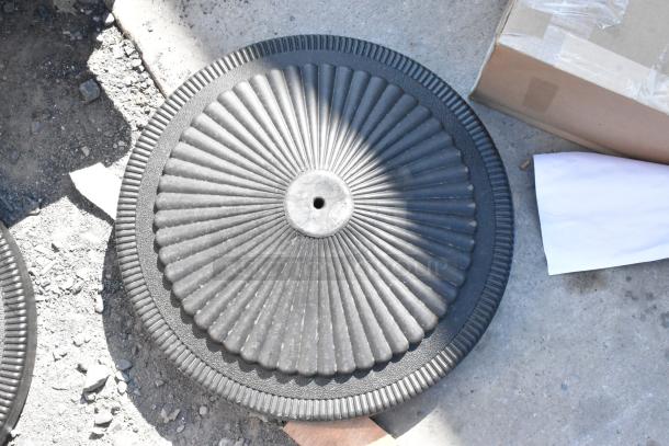 Black metal table base foot, brand new, scratch and dent, fluted design, no visible labels, intended for sturdy support.