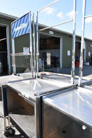 Stainless steel cart with under shelf and commercial casters, featuring a "Tastes & Tips" sign. Excellent condition.