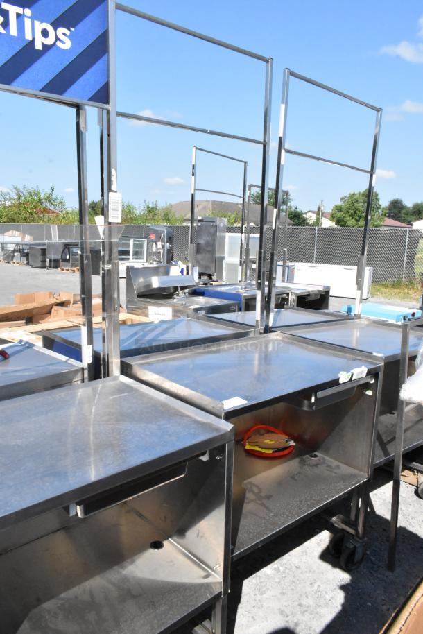 Stainless steel cart with under shelf, commercial casters, outdoor setting, durable surface, good condition.