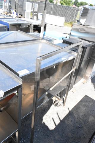 Stainless steel cart with under shelf, featuring commercial casters for mobility. Good condition, ideal for industrial use.