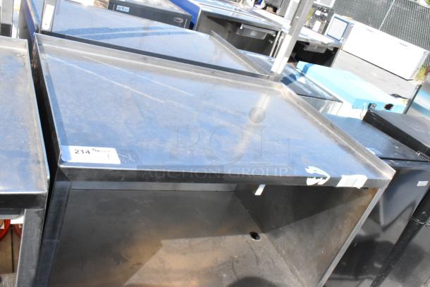Stainless steel cart with under shelf and commercial casters, shows minor surface wear. Label marked "214".