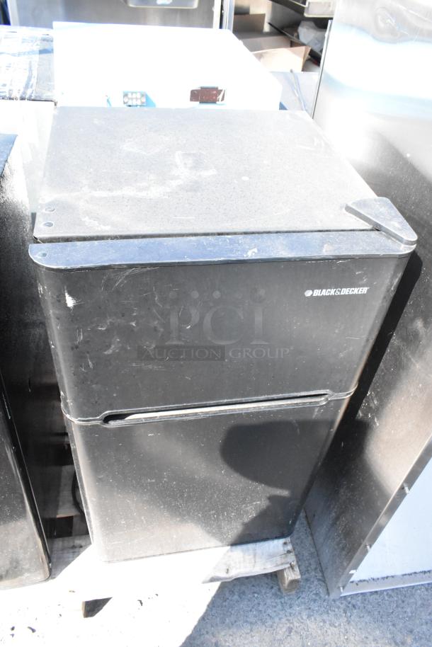 Black & Decker BCD33B mini cooler, moderate wear, black finish, visible scratches, on wooden pallet for auction.