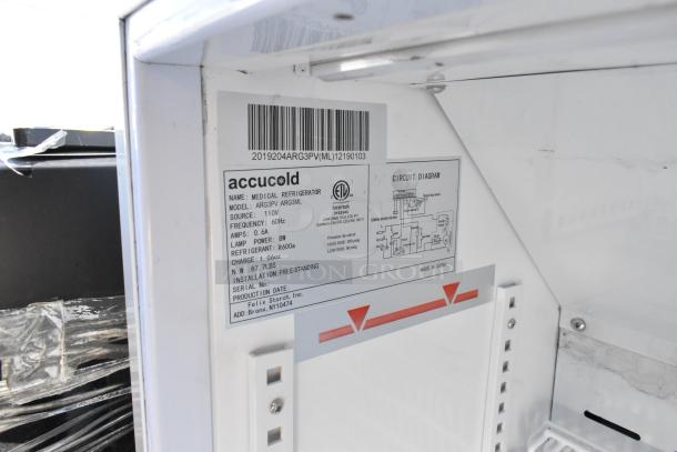 Interior view of Accucold ARG3PV mini cooler with specifications label, showing model details, power source, and diagram.