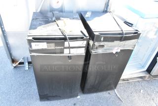 Two Galanz GLR33MBKE23 mini coolers, black, 120 volts, 1 phase, taped cords, visible wear. Auction includes both units.