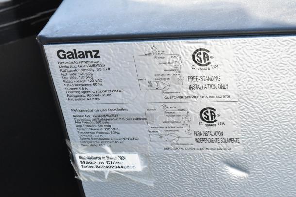 Galanz mini cooler, model GLR33MBKE23 label. Capacity 3.3 cu. ft, 120V, 1 phase. Made in March 2024, China.