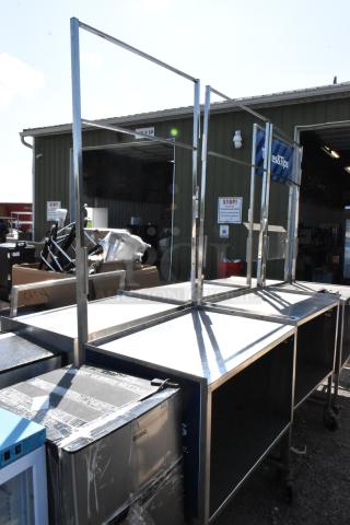 Stainless steel cart with under shelf, commercial casters, sturdy frame, ideal for restaurant or industrial use.