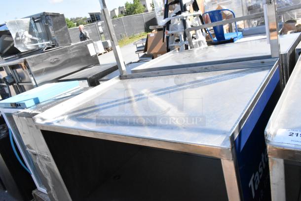 Stainless steel cart with under shelf on commercial casters, showing a sturdy frame, reflective surface, and light wear.