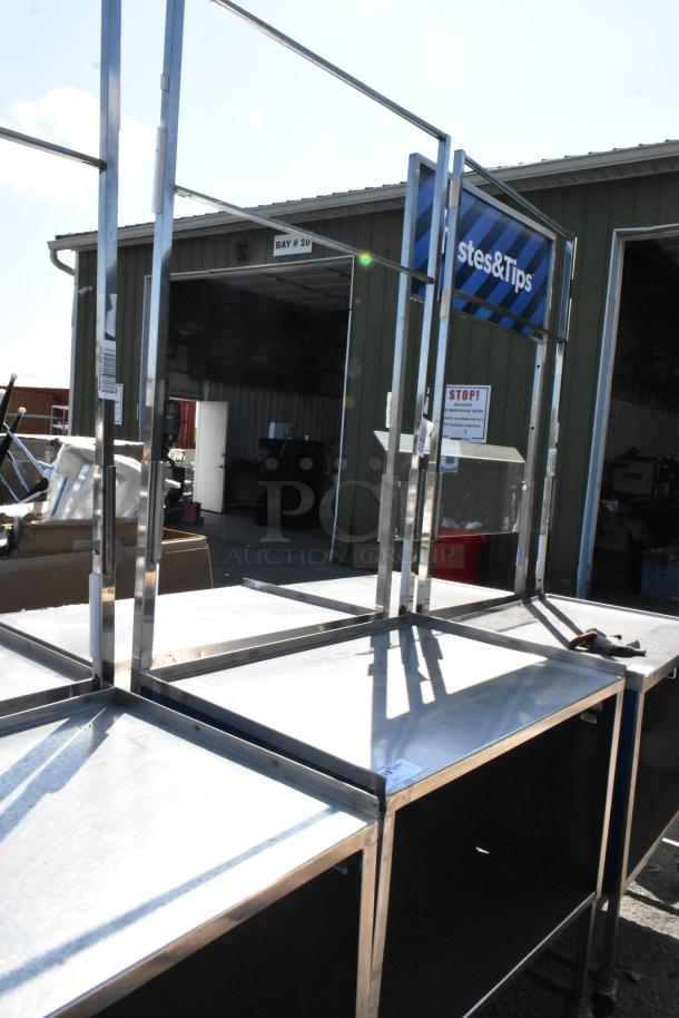 Stainless steel cart with under shelf, on commercial casters, featuring additional framework. Slight surface wear evident.