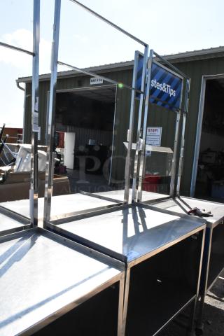 Stainless steel cart with under shelf, on commercial casters, featuring additional framework. Slight surface wear evident.