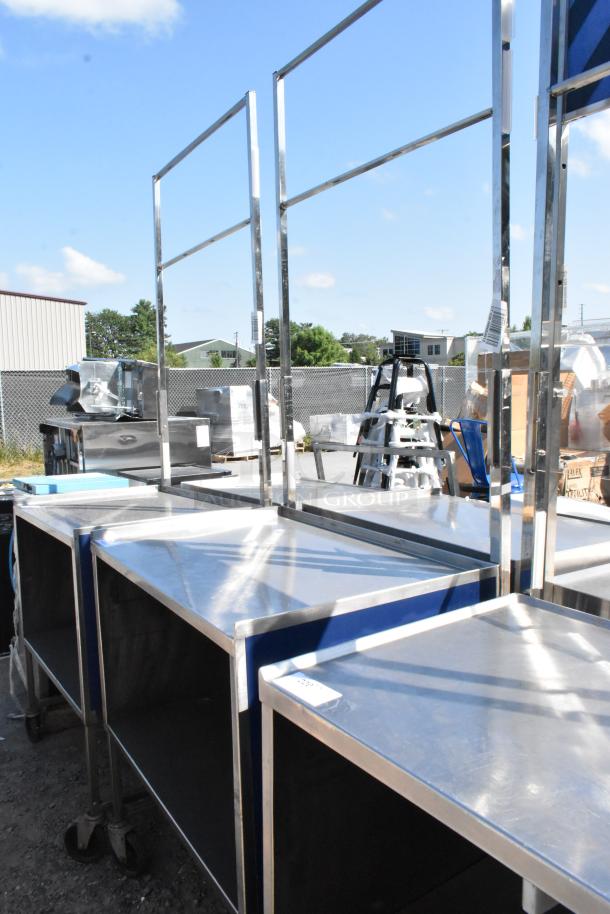Stainless steel cart with under shelf on commercial casters, featuring a robust design and shiny finish, ideal for heavy-duty use.
