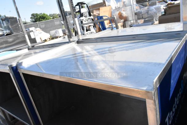Stainless steel cart with under shelf on commercial casters, featuring sturdy construction and smooth surface. Ideal for commercial use.
