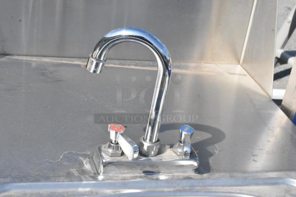 QualServ stainless steel portable sink with single bay, chrome faucet, and commercial casters, showing some surface wear.