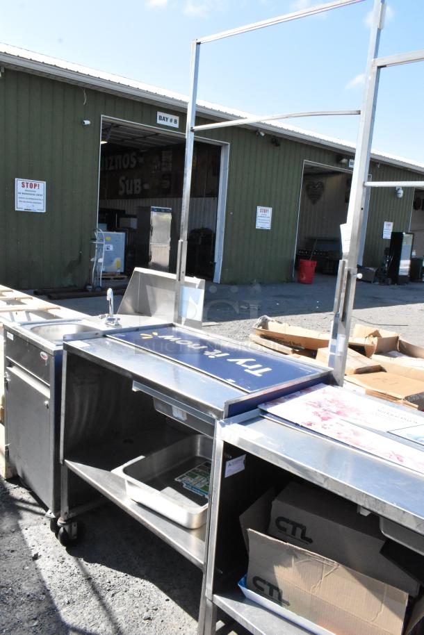 Stainless steel cart with under shelf, faucet, and commercial casters. Includes workspace and storage. Visible "Try it now" sign.