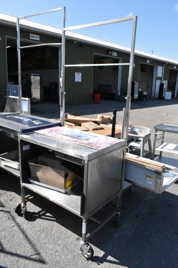 Stainless steel cart with under shelf, commercial casters, sturdy condition, suitable for industrial or kitchen use.