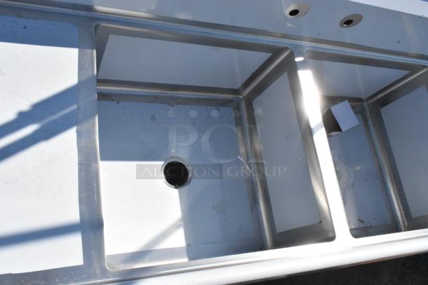Brand new Regency 600S3242424S stainless steel sink, 124" with three 24" x 24" x 14" compartments, includes two drainboards.