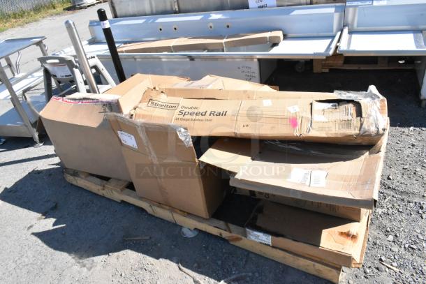 Pallet of 15 scratch and dent items, including a Trash Can Dolly, in original packaging. Boxes show signs of wear.
