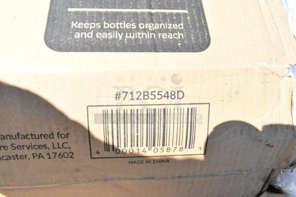 Cardboard box with barcode #712B5548D and "Made in China." Contains scratch and dent items like trash can dolly, wine glasses.