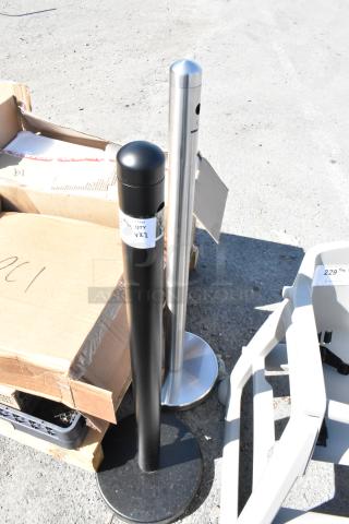 Two Smokers Outposts, one chrome and one black, standing outside. Chrome outpost has a sleek finish, both in good condition.