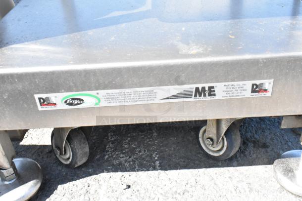 Face to Face stainless steel meat slicer equipment stand on commercial casters, showing manufacturer labels.