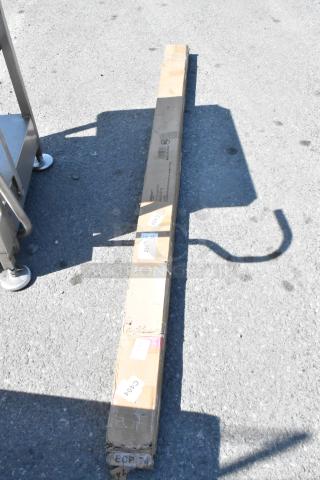 Brown cardboard packaging of a Regency 460ECP74 74" chrome post, labeled "NSF." Box has visible wear, indicating "scratch and dent" condition.