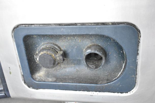 Close-up of Alto Shaam CTP10-10E combi oven's control panel with visible wear, showing a knob and open socket.