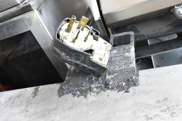A damaged power plug for an Alto Shaam CTP10-10E combi convection oven, showing burn marks and debris.