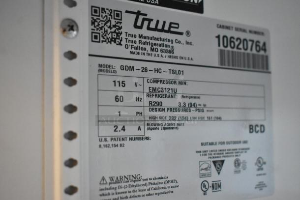 Label showing specifications for Treu GDM-26-HC cooler. Details include 115 volts, 1 phase, R290 refrigerant, and compressor model EMC3121U.